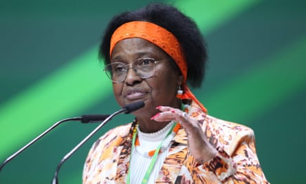 Pierrette Herzberger-Fofana gestures while speaking behind two microphones