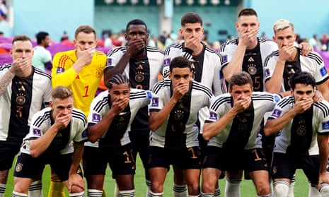 Germany’s players cover their mouths before the start of their World Cup game against Japan.
