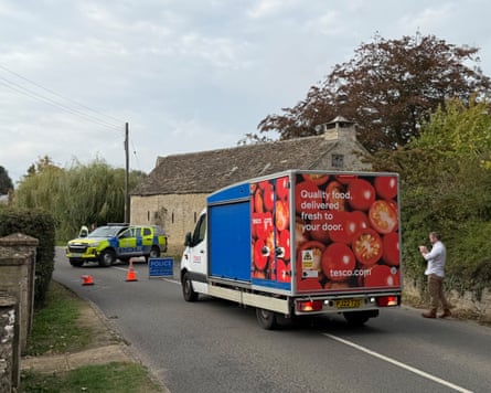 A Tesco grocery delivery vehicle stopped at a police roadblock