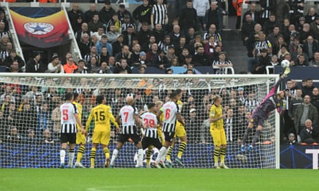 Borussia Dortmund goalkeeper Gregor Kobel saves a shot at goal at Newcastle.