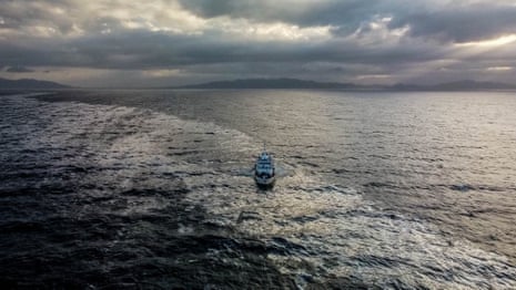 A ship at sea amid an oil slick.