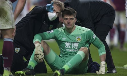 Burnley’s goalkeeper Nick Pope goes through the concussion protocol with medical staff after a blow to the head in Monday’s game with Crystal Palace.