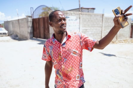 Venel Nelson stands in a street pointing
