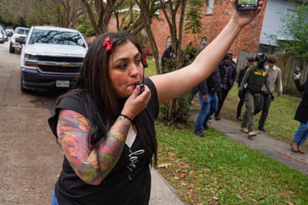 person wearing black shirt blows into whistle