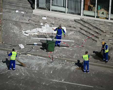 Municipal workers clear debris from the street after a Russian drone struck an apartment building in Galați, eastern Romania.