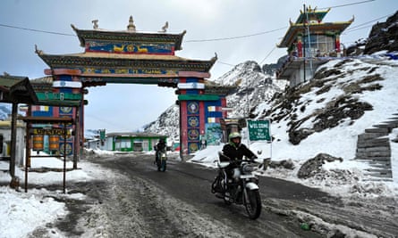 Motorbike riders cross into the Himalayan Sela pass in Tawang, Arunachal Pradesh.