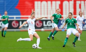 Leah Williamson of England passes the ball under pressure from Simone Magill of Northern Ireland.