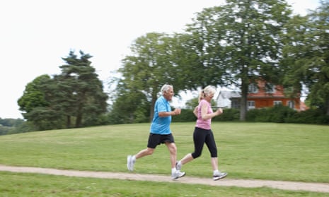Older couple jogging together outdoors