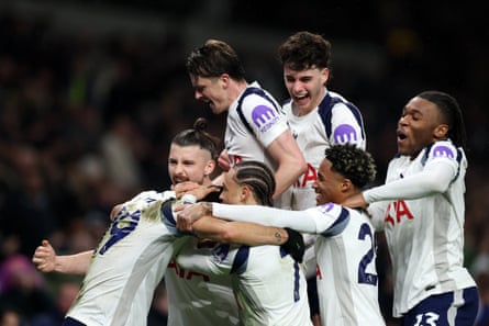 Dominic Solanke is mobbed by his Spurs teammates after his equaliser