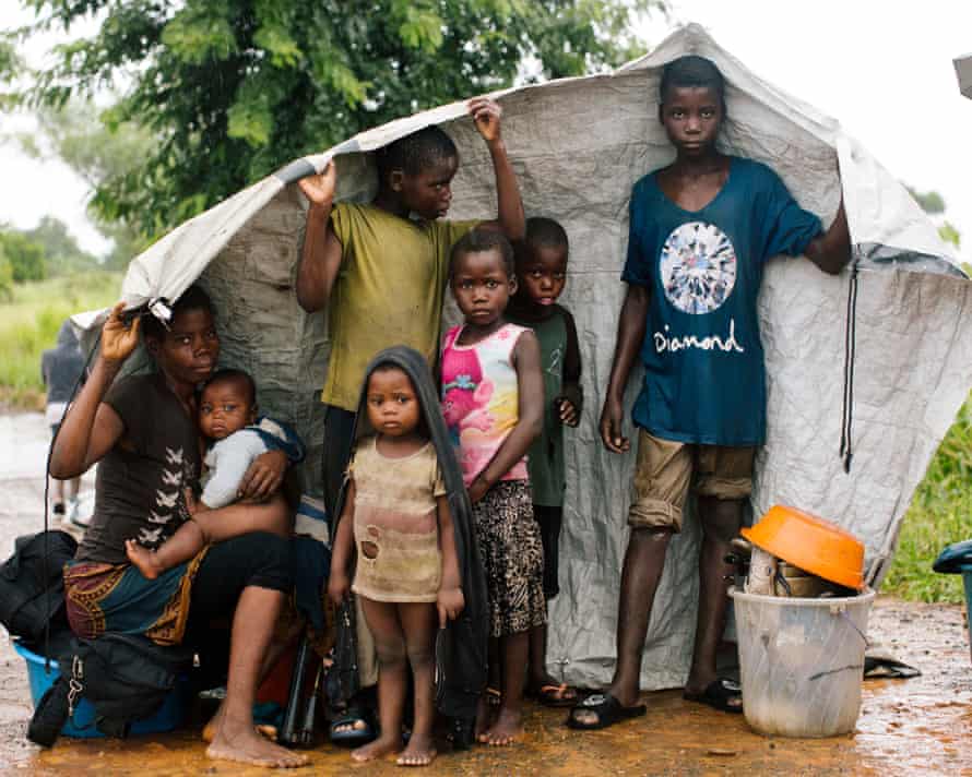 Maria Mussa with her children and all their belongings, 24 hours after their home was flooded