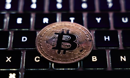 A laptop keyboard and representation of Bitcoin cryptocurrency