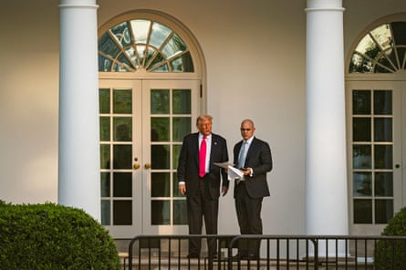 Donald Trump speaks with an advisor