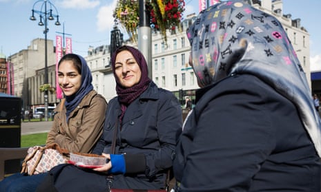 Three women in headscarves on park bench