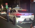 Police officer looking into driverless car