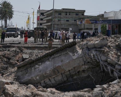 People check a bridge destroyed in an Israeli airstrike in Qasmiyeh, near the coastal city of Tyre, in southern Lebanon on Thursday before the truce