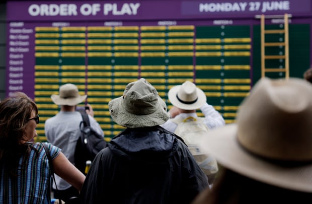 A variety of hats at the order of play board