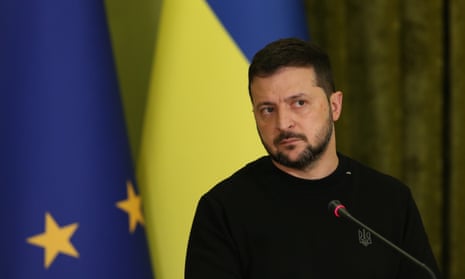 Volodymyr Zelenskiy with Ukrainian flag behind him