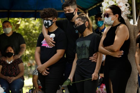  Family gather at the funeral of Fernando Aquirre who died of Covid-19 at the age of 69, on 20 July.