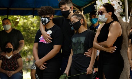 Family gather at the funeral of Fernando Aguirre, who died of Covid-19. A graduation party led to many family members testing positive for the virus. 