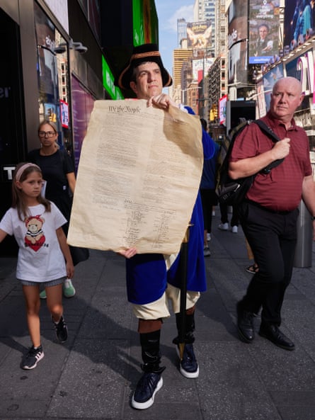 AJ Jacobs in 18th-century dress in New York City, holding a copy of the US constitution