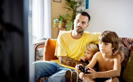 Dad and sons playing video game together and having fun
