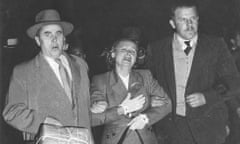 Evdokia Petrov at Mascot airport in Sydney, being ‘escorted’ across the tarmac to a waiting plane by two armed Russian diplomatic couriers on 19 April 1954