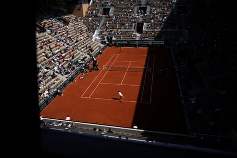 Jasmine Paolini (bottom) serves to Elina Avanesyan during their fourth round match of the French Open.