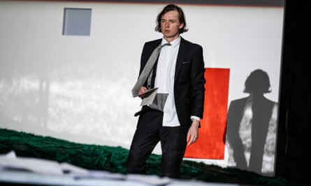 Actor Mārtiņš Meiers in a black-and-white suit on stage in Winter’s Tale