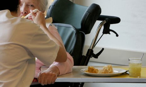 A care nurse helps a pensioner during lunch in a residential home for the elderly in Emmenbruecke
