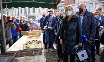 Marine Le Pen visiting market all in masks.