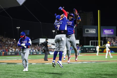 Darell Hernaiz and Christian Vázquez of Puerto Rico celebrate runs against Colombia during the fifth inning on Friday at Hiram Bithorn Stadium in San Juan, Puerto Rico.