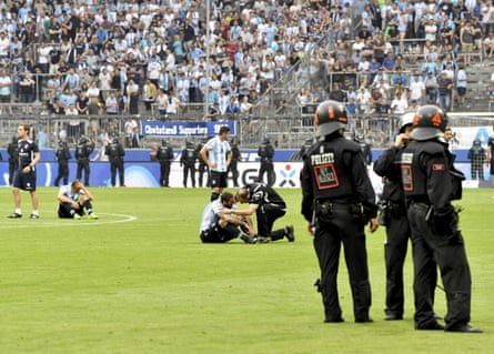 1860 Munich players sit on the pitch after losing the German Bundesliga 2nd division relegation match against Jahn Regensburg in the Allianz Arena