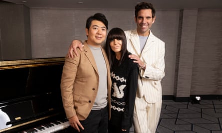 Lang Lang, Claudia Winkleman and Mika standing next to a piano