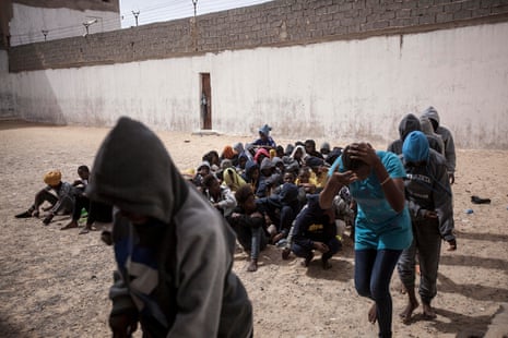 Female migrants queue in the prison yard as they are taken into buses to be transferred to another detention centre after they were sold by the militia group ruling the Surman detention camp in the west of Libya