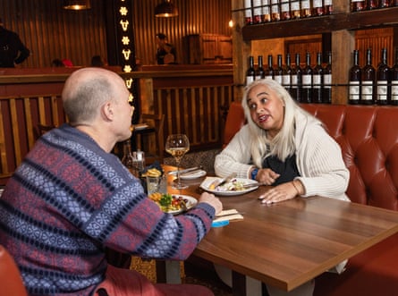 Fred and Maxine chatting across a restaurant table