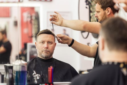 Jon McSherry, having his Nova Cabelo-brand hair system trimmed by barber Thomas Robinson.