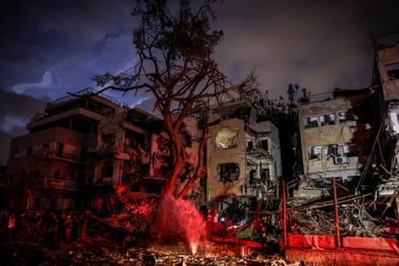Emergency staff in front of damaged buildings