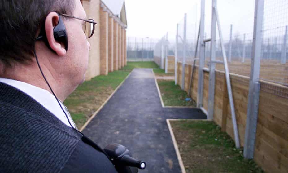 A security guard surveys the boundaries of Yarl’s Wood immigration removal centre, near Bedford. 