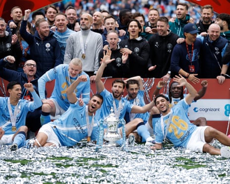 Manchester City players and staff celebrate with the FA Cup trophy