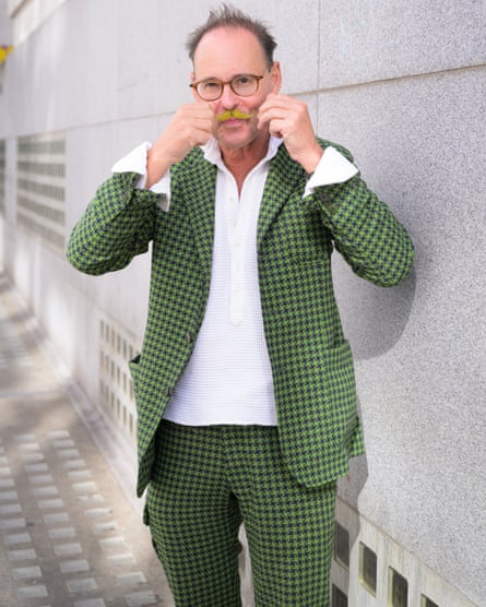 Guy Hills wearing green tweed suit, twirling his green moustache