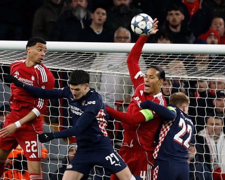 Liverpool's Virgil van Dijk handles the ball before the referee awards a penalty to PSV Eindhoven.