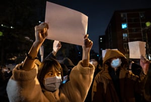 Protesters hold up blank pieces of paper to protest against censorship and China’s strict zero-Covid measures in Beijing