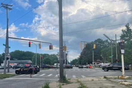 Suburban, treelined street with police SUVs