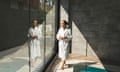 A woman in a white bathrobe enjoying a luxury spa with a swimming pool