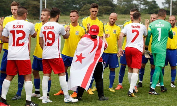 Northern Cyprus and Karpatalya shake hands before their match at Enfield.