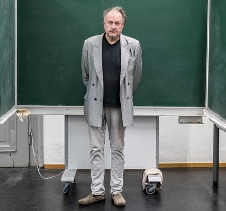 Jürgen Wertheimer, who set up Project Cassandra, standing in front of a green chalkboard