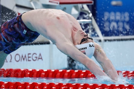 Hunter Armstrong, the American swimmer, dives backwards into the pool to start a backstroke race.