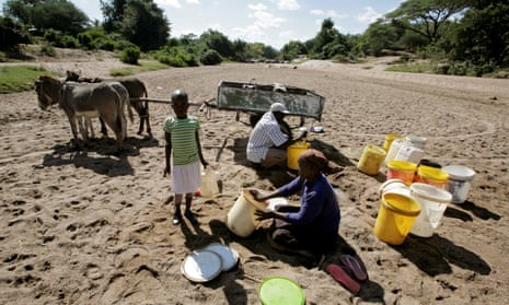 Villagers attempt to collect water from a dry river bed in drought-hit Masvingo, Zimbabwe on 2 June 2016.
