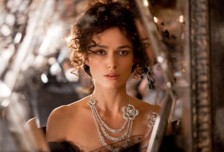 In the title role of Anna Karenina, head and shoulders shot of Knightley in an off-the-shoulder dress with a fancy necklace.