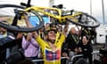 Kasia Niewiadoma holds her bike aloft after her victory in the Tour de France Femmes